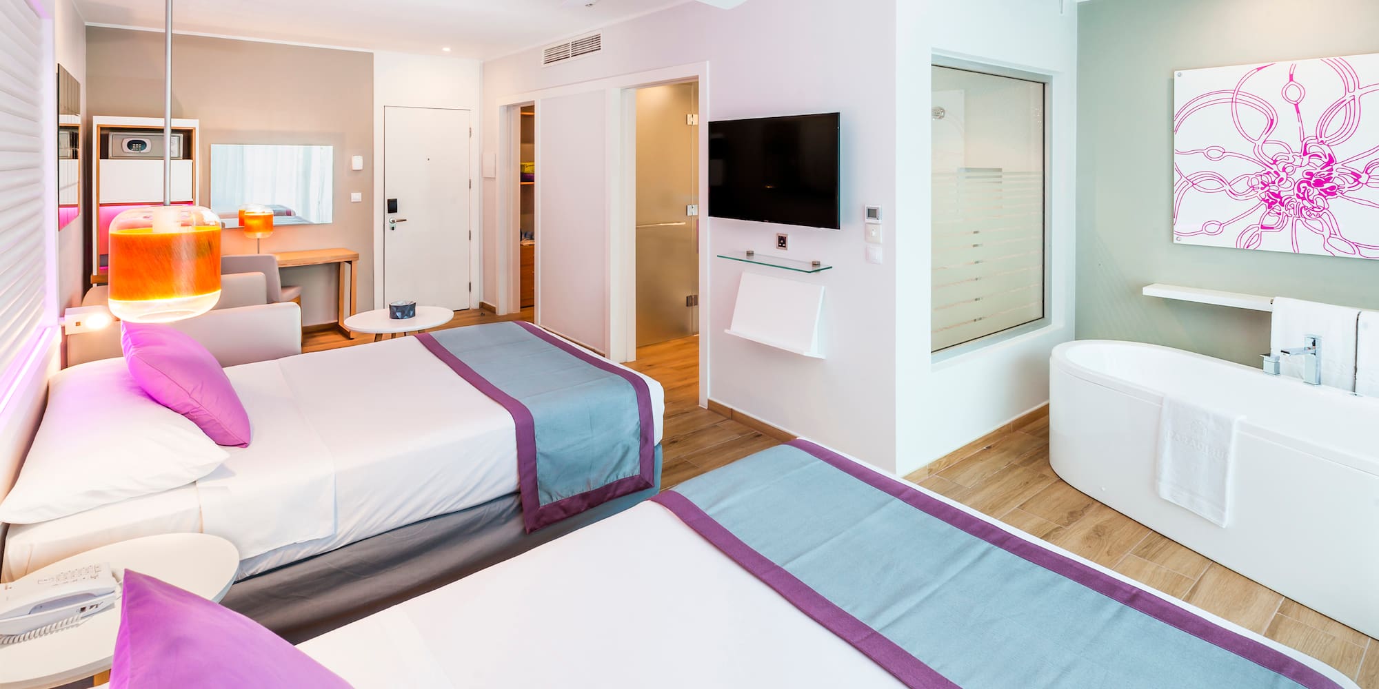 a room with two beds and a tub