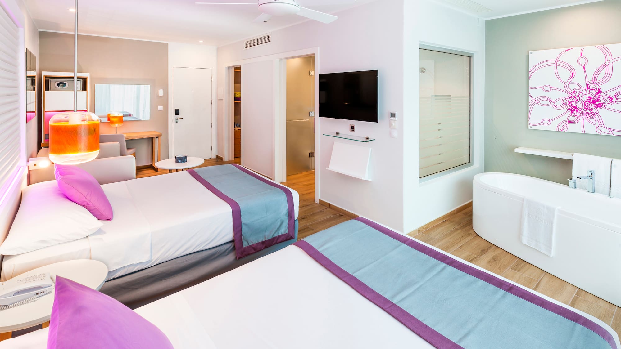 a room with two beds and a tub