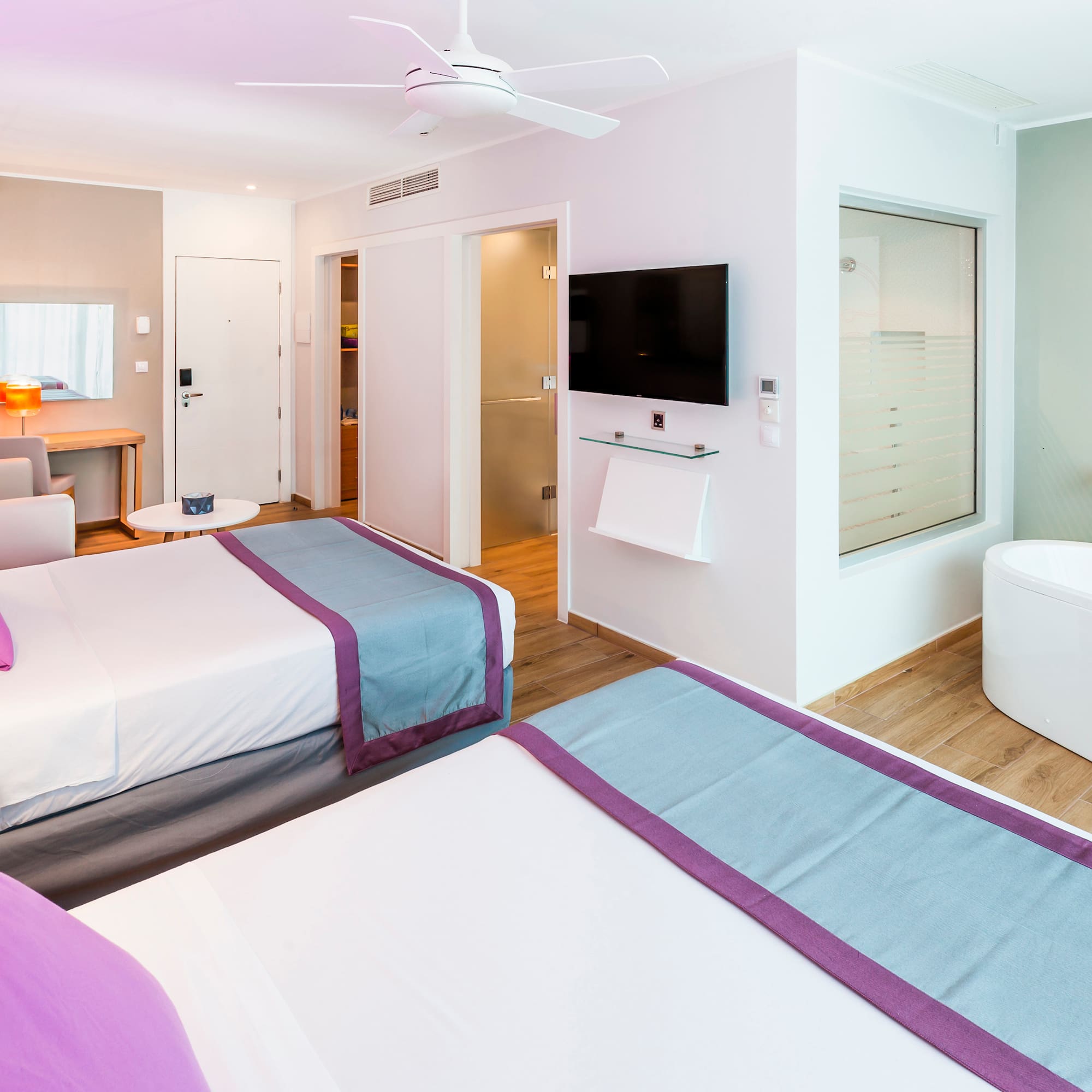 a room with two beds and a tub