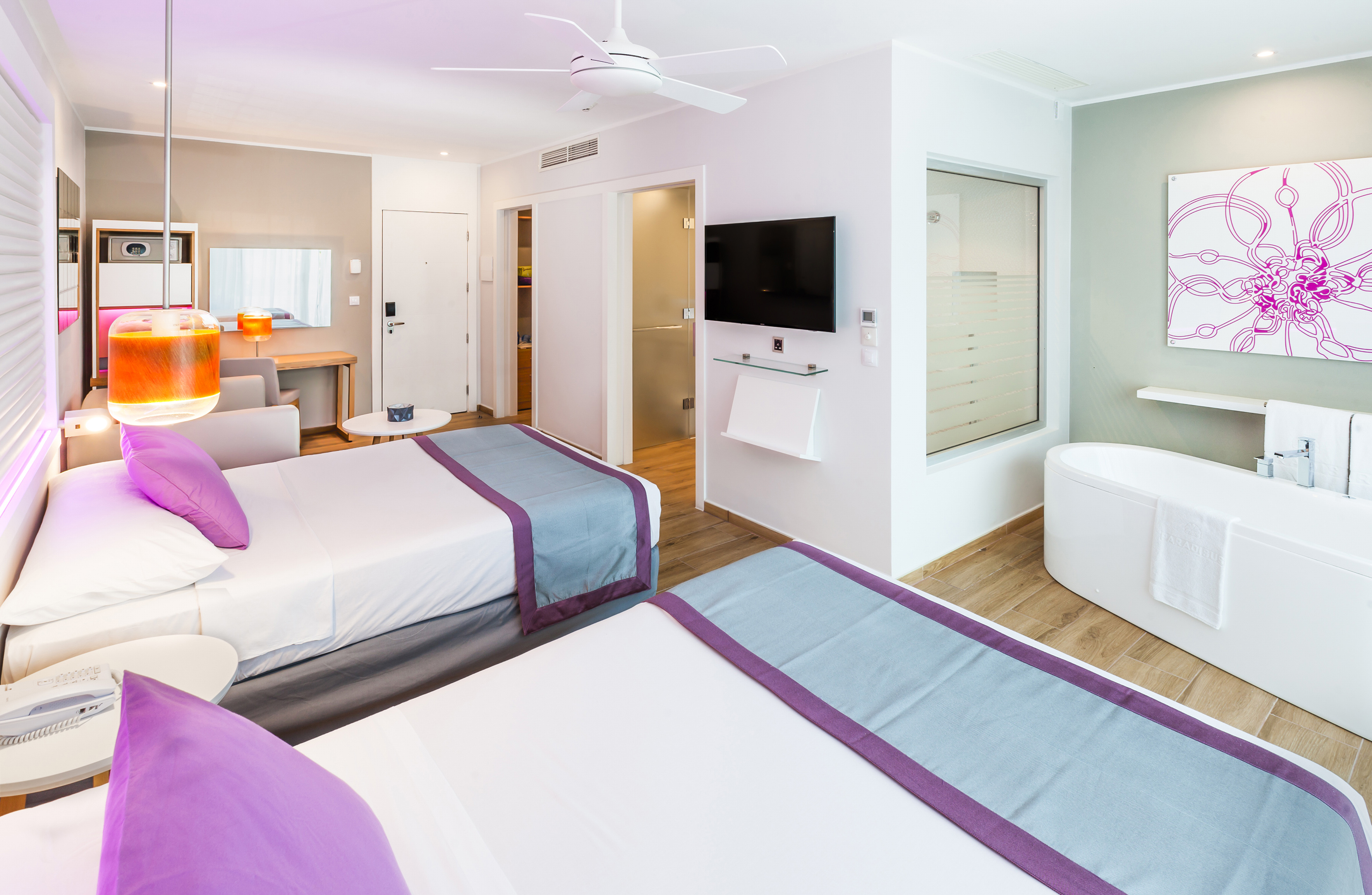 a room with two beds and a tub