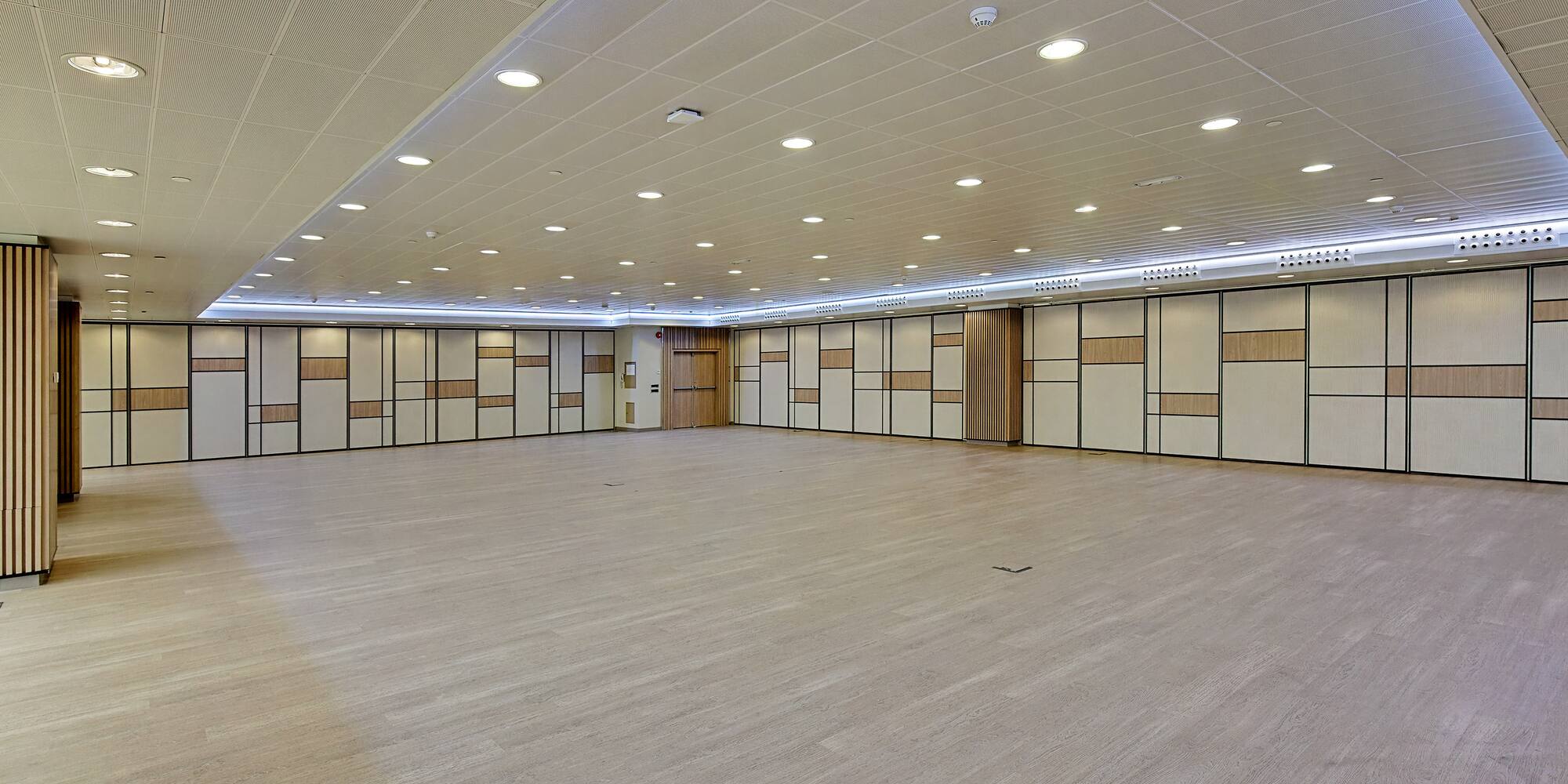 a room with doors and a wood floor