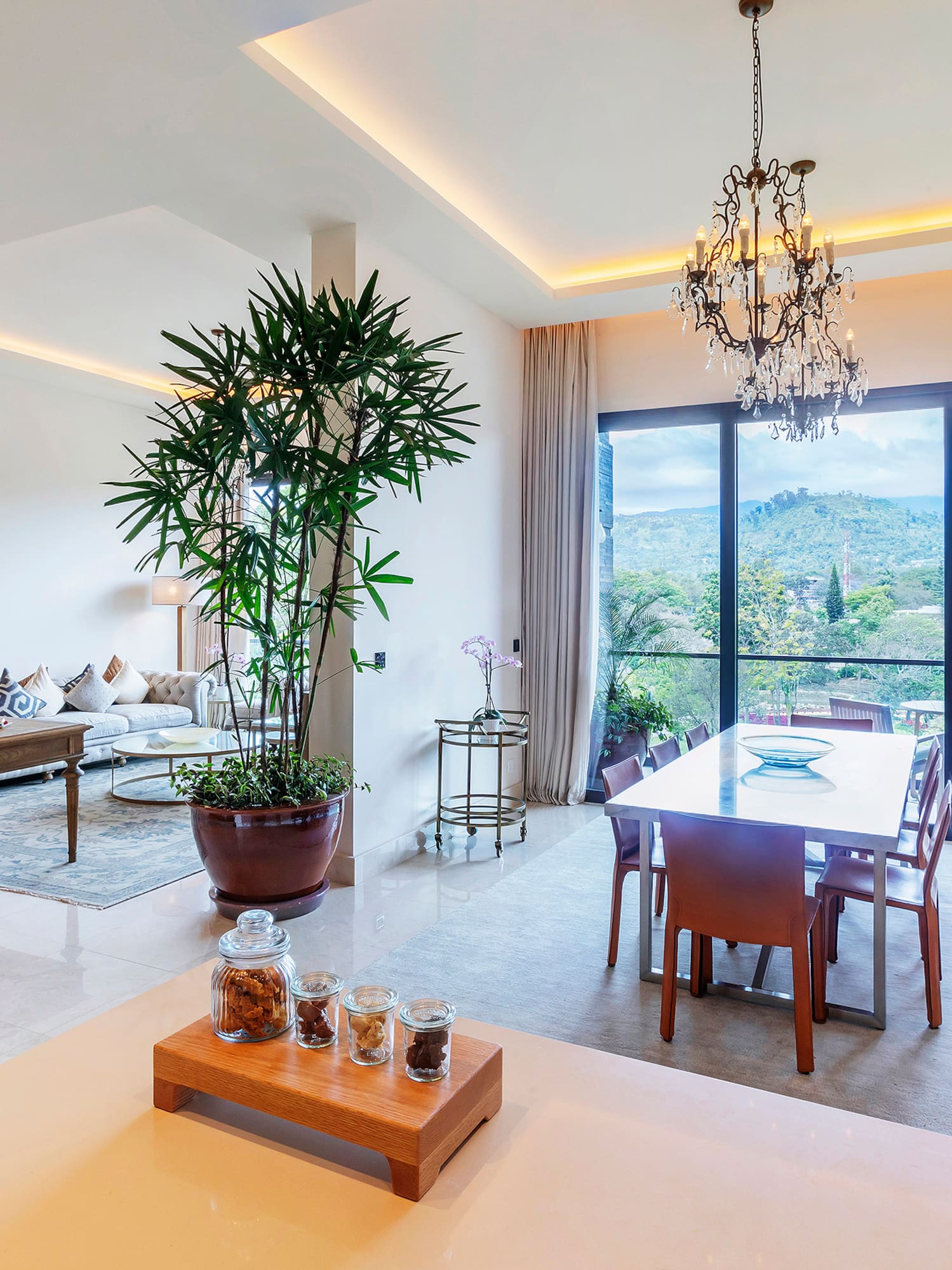 a room with a table and chairs and a large window