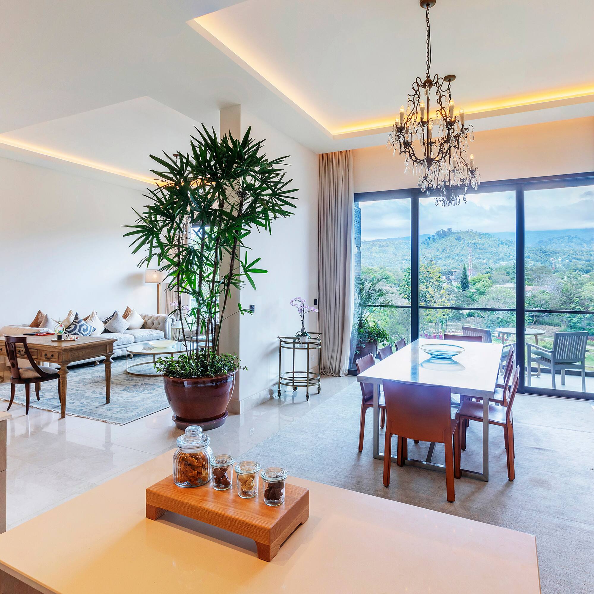 a room with a table and chairs and a large window