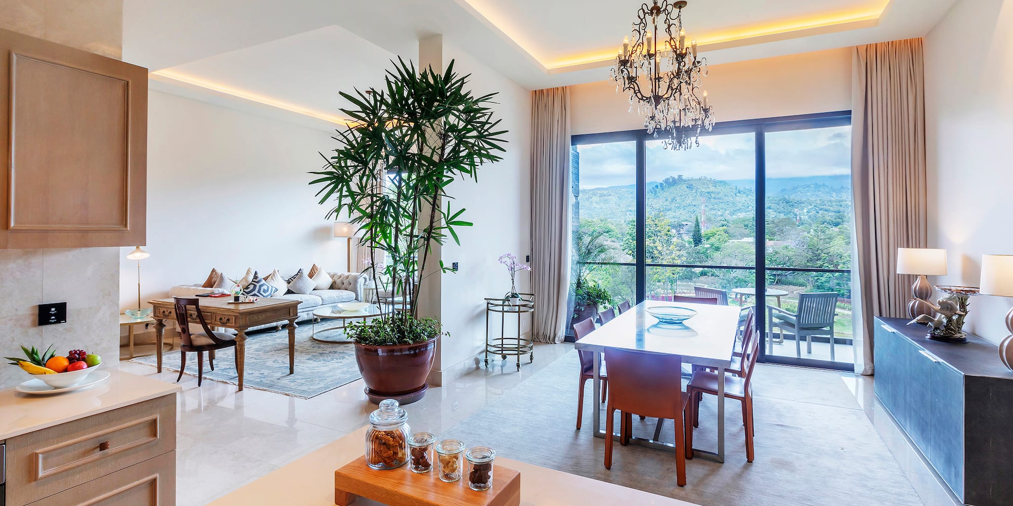 a room with a table and chairs and a large window