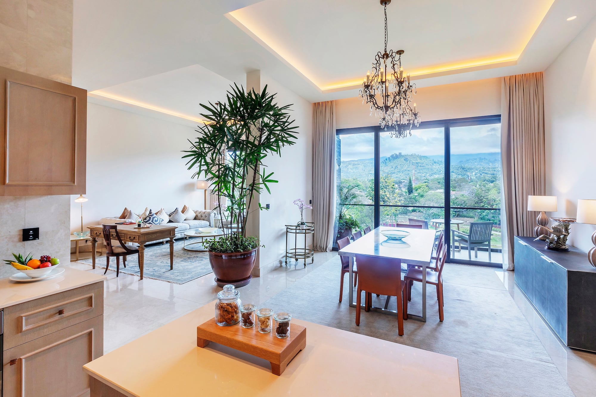 a room with a table and chairs and a large window
