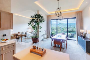 a room with a table and chairs and a large window