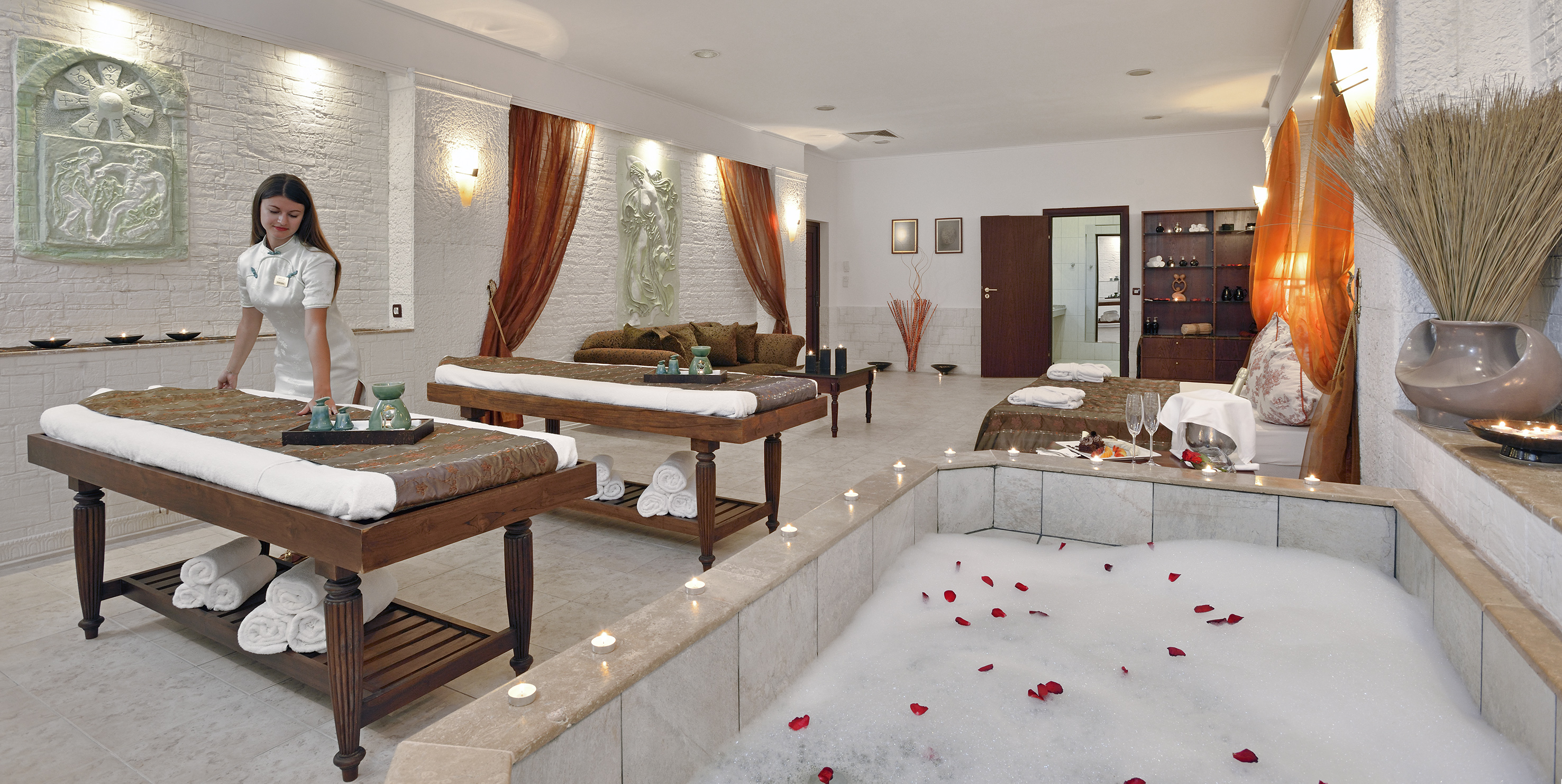 a room with a bathtub and tables