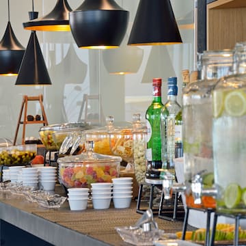 a buffet table with different drinks and fruits