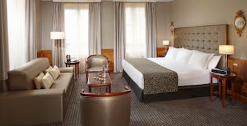 a hotel room with a bed and a couch