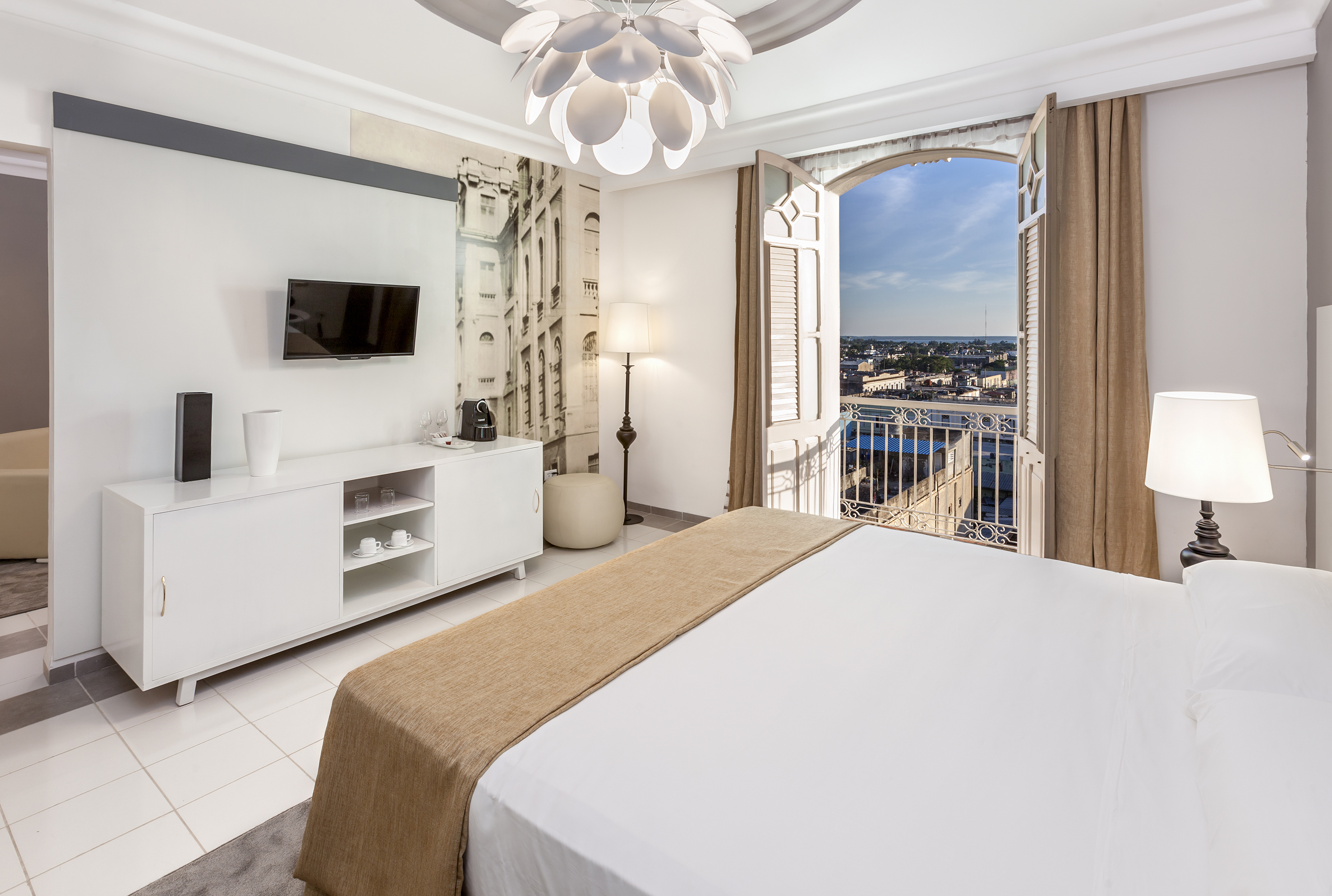 a bedroom with a large bed and a television