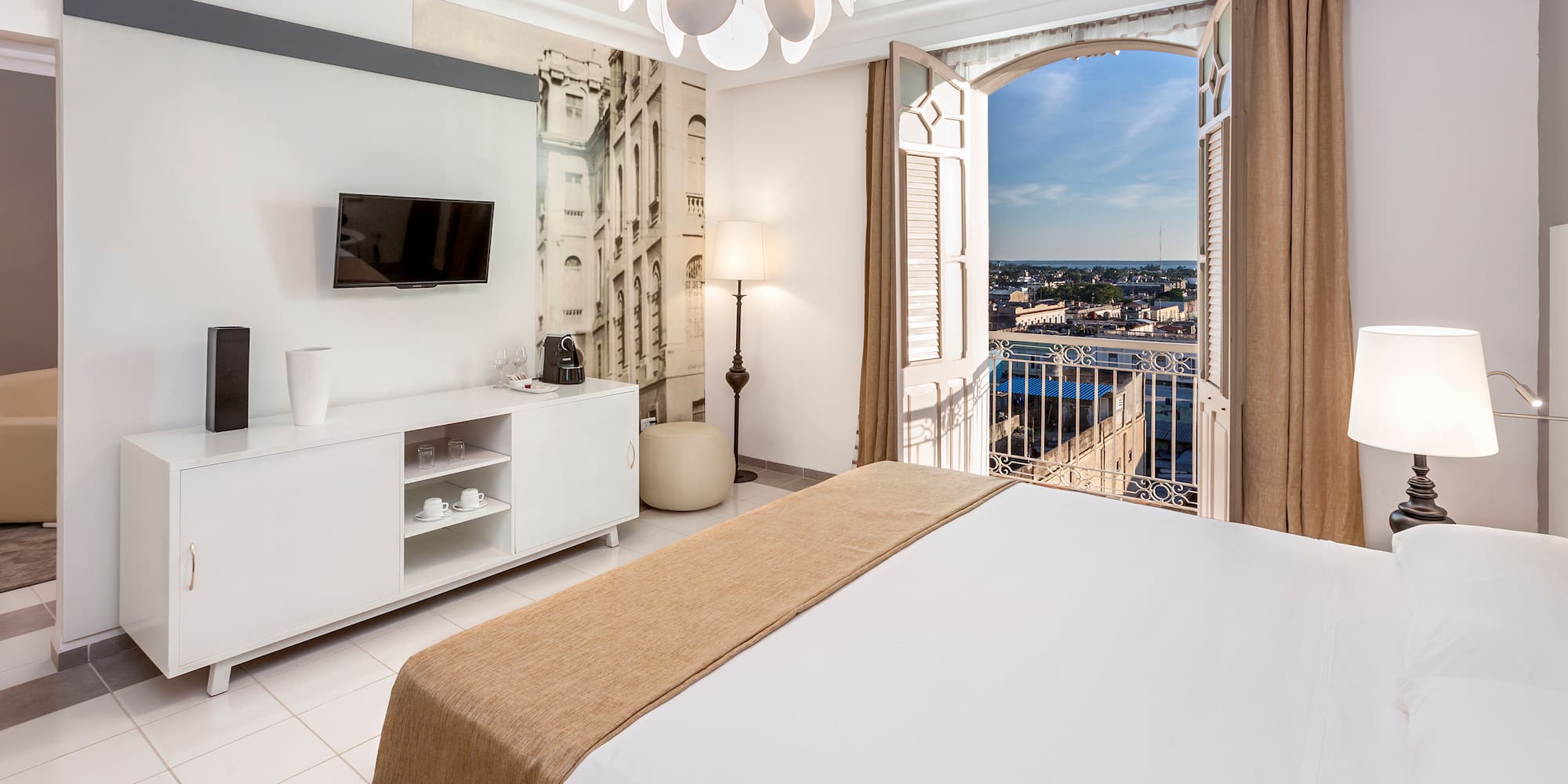 a bedroom with a large bed and a television