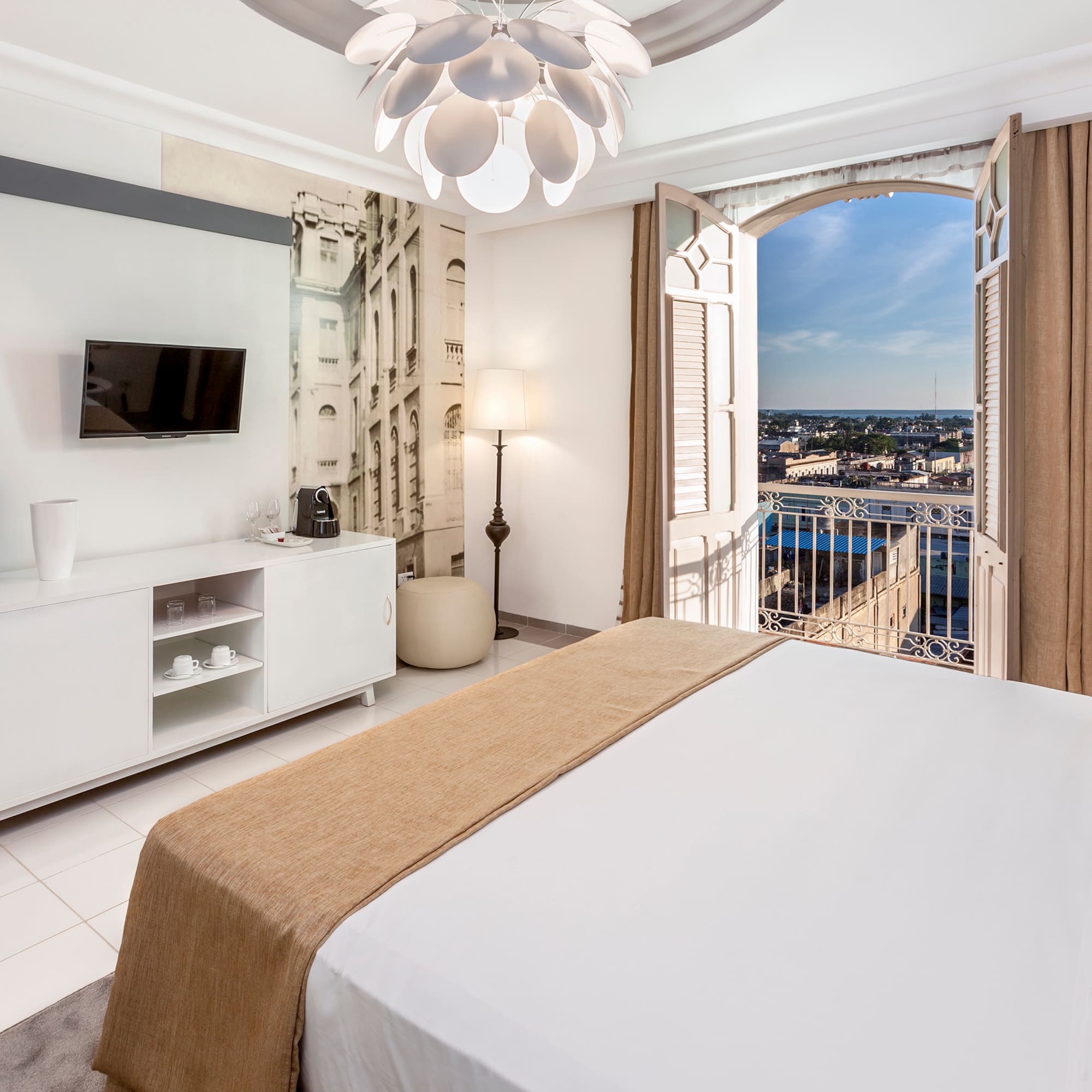 a bedroom with a large bed and a television