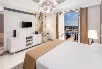 a bedroom with a large bed and a television