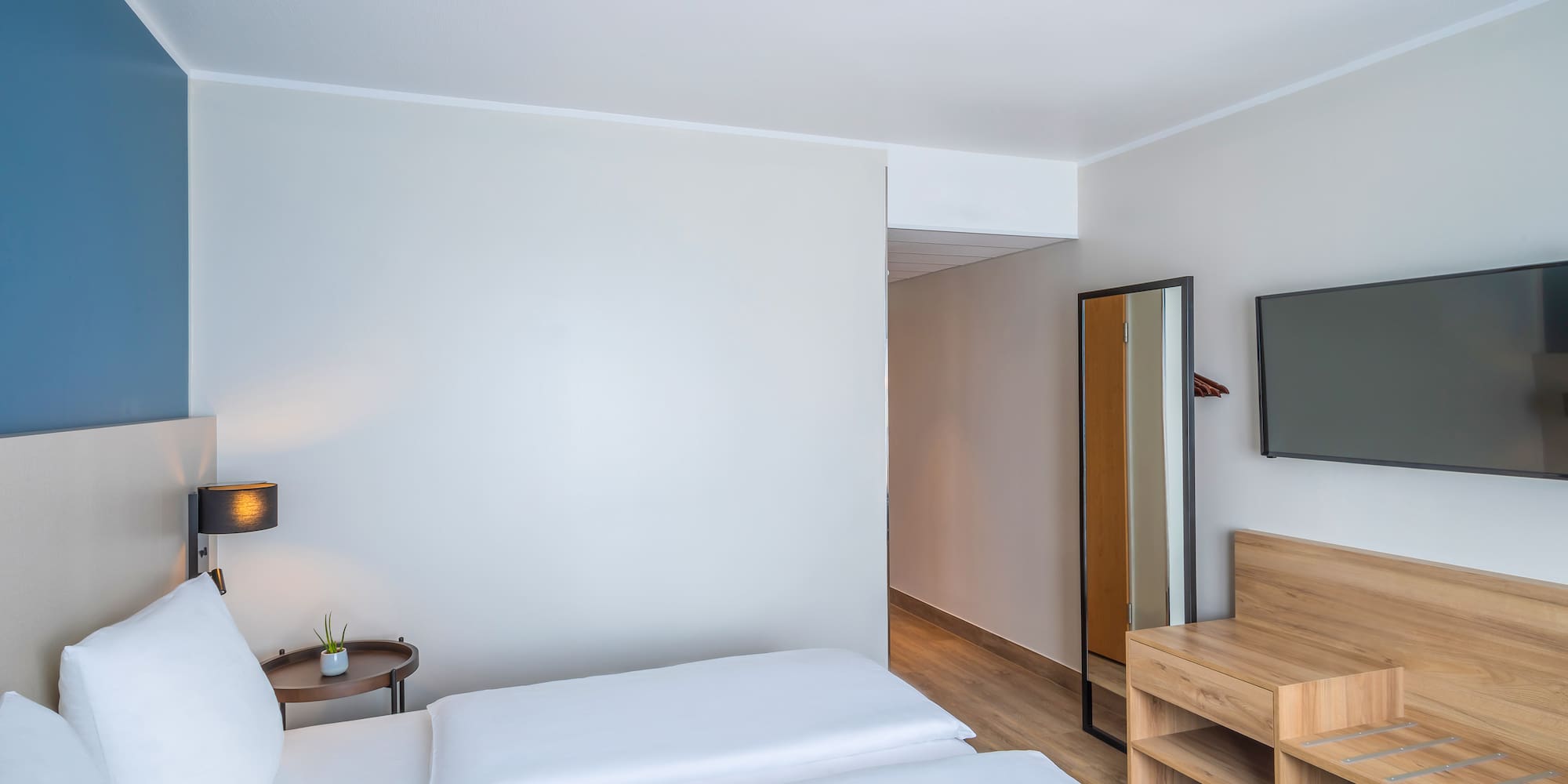 a room with a bed and a mirror