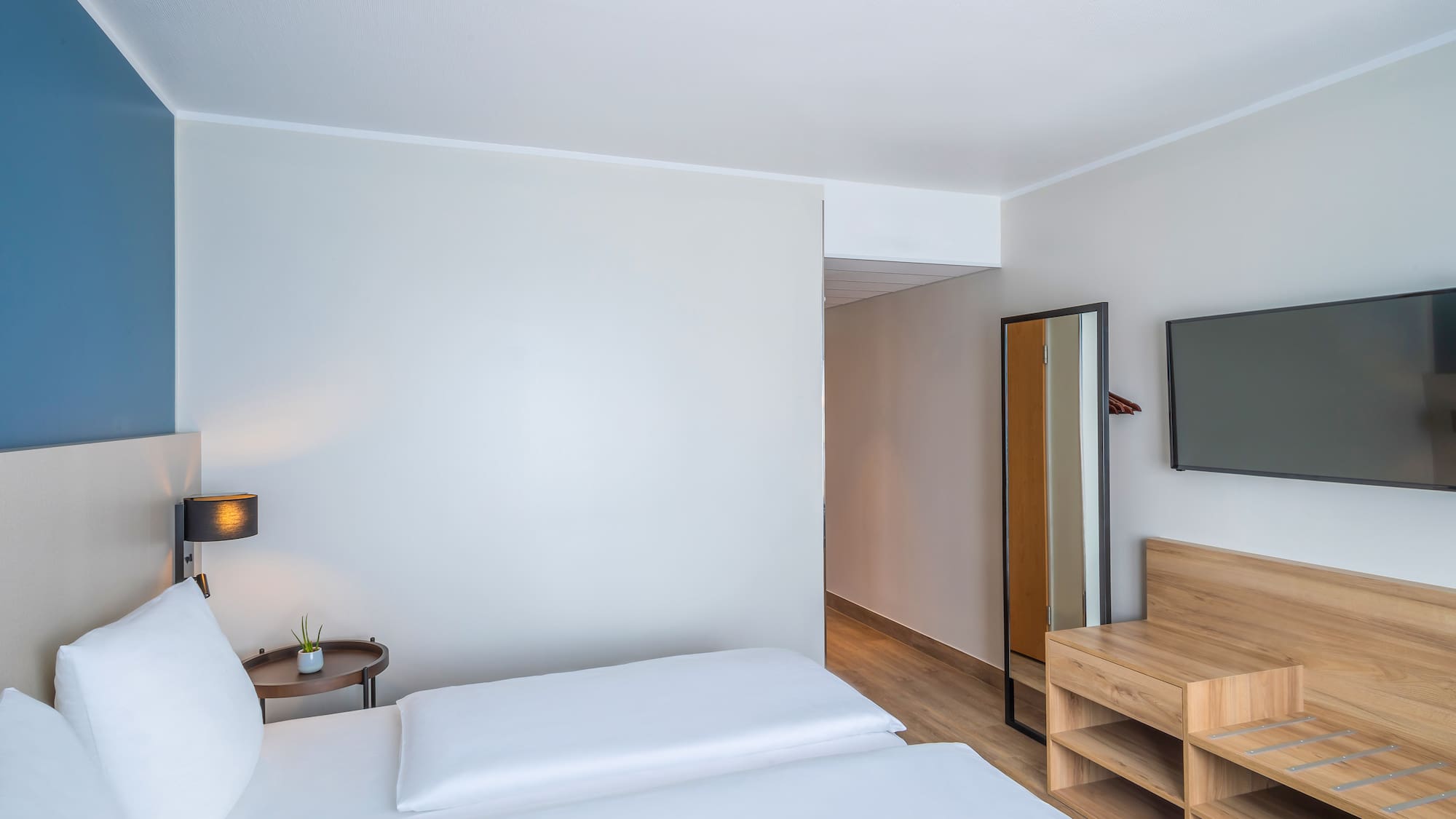 a room with a bed and a mirror