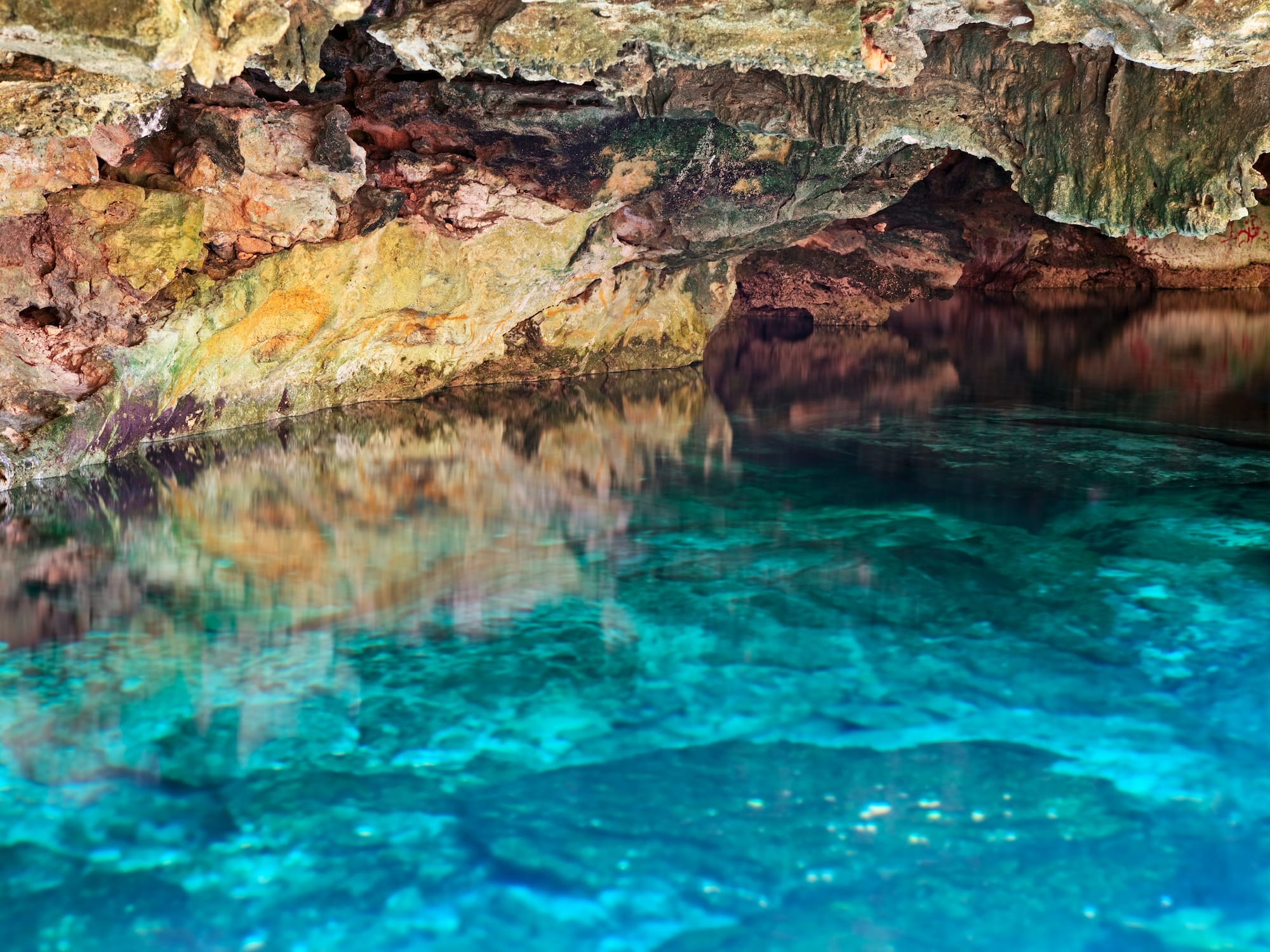 a cave with a blue water
