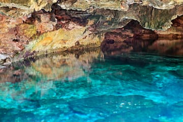 a cave with a blue water