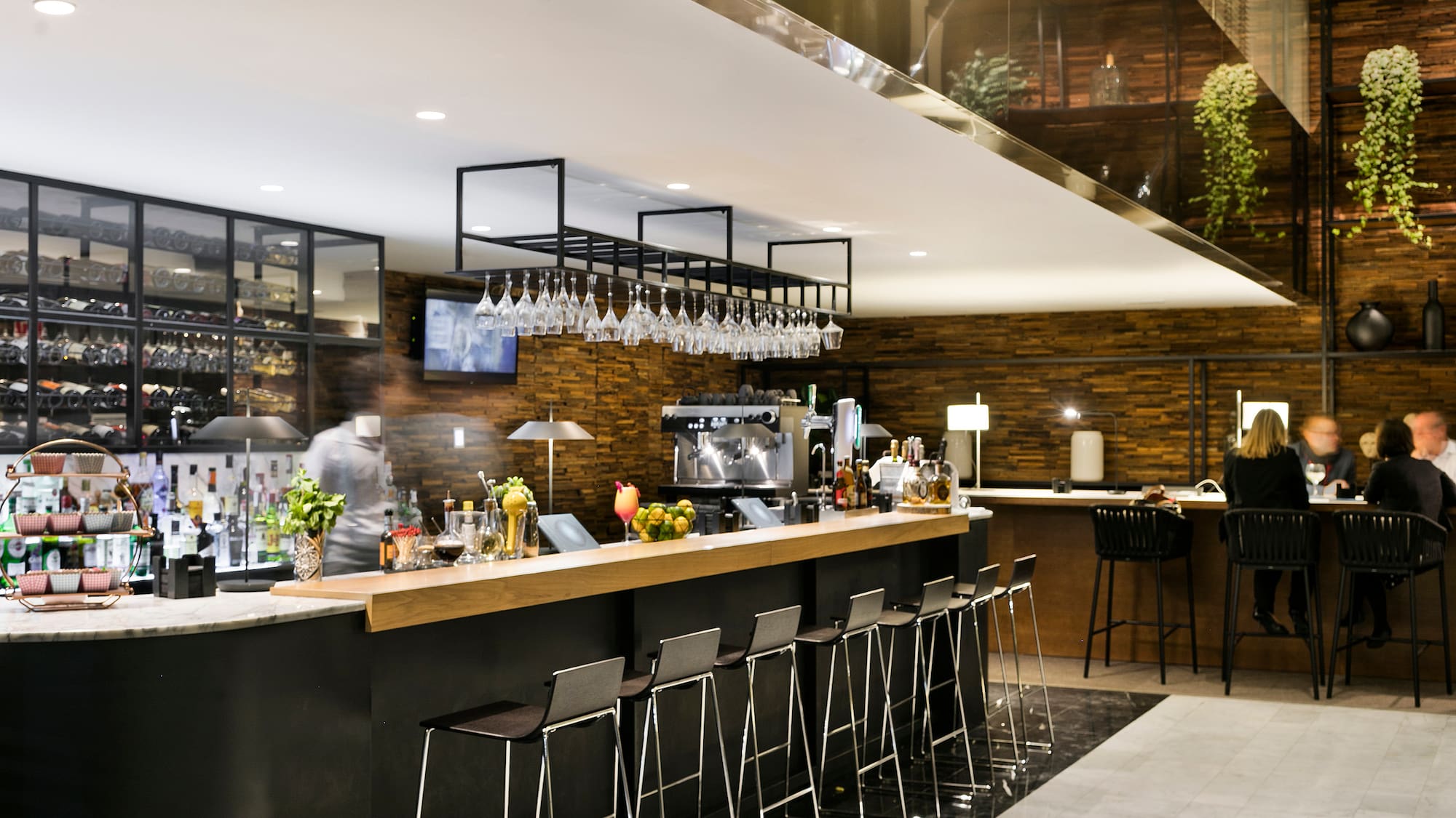 a bar with a counter and chairs