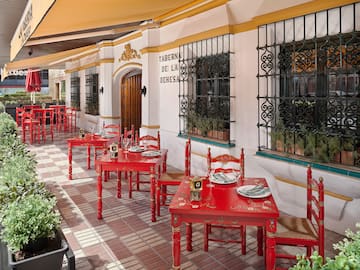 a restaurant with red tables and chairs