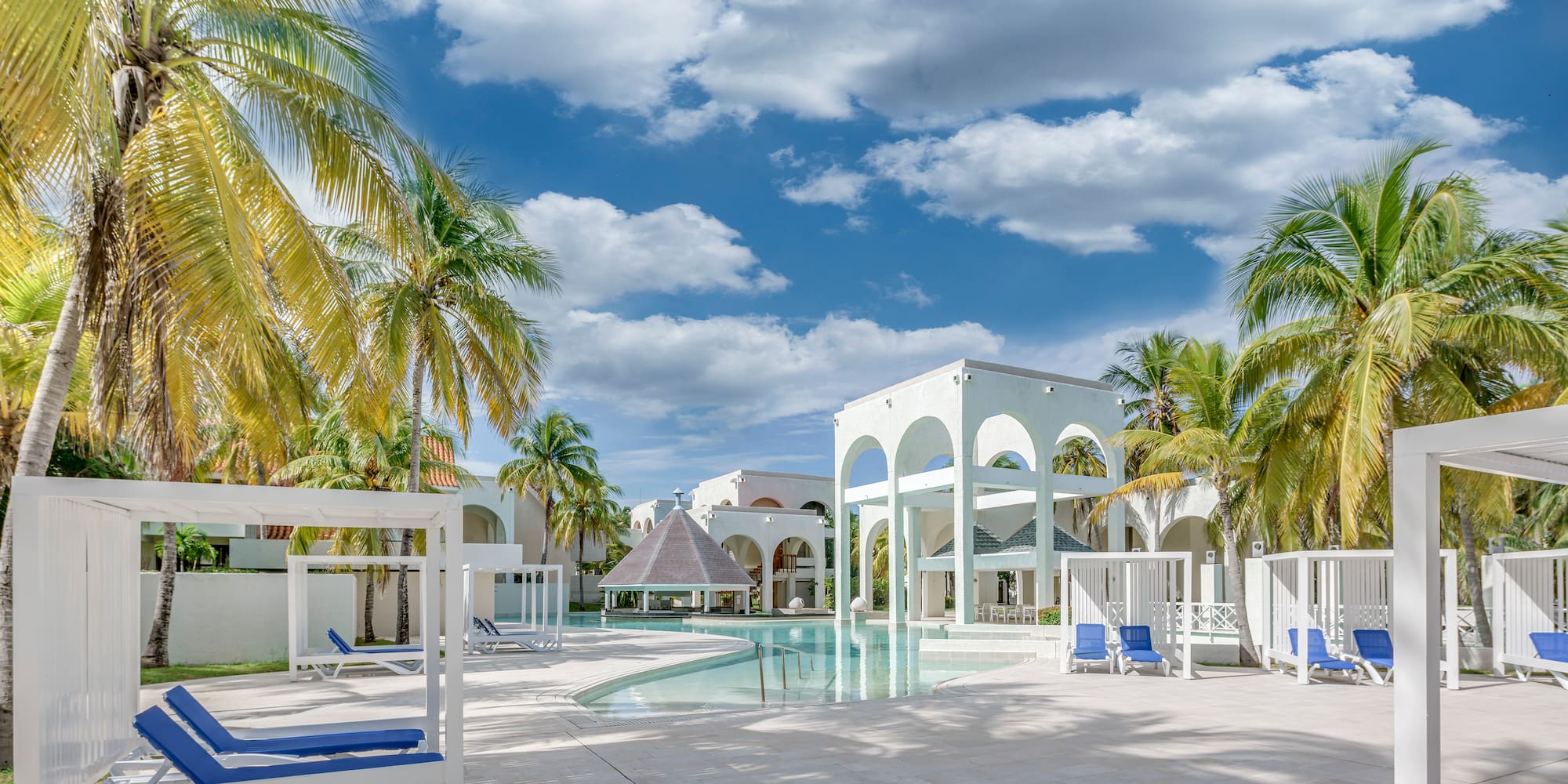 a pool with a gazebo and palm trees
