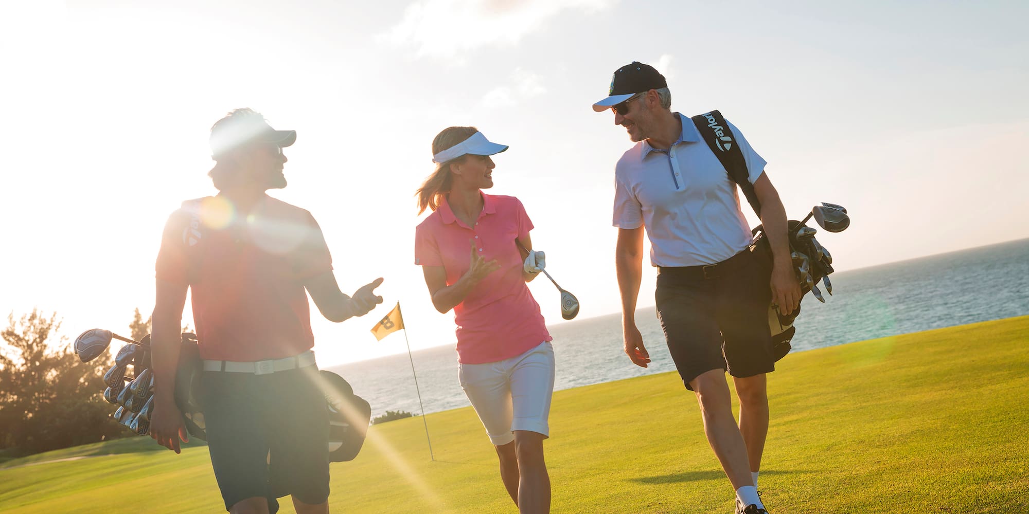 a group of people walking on a golf course