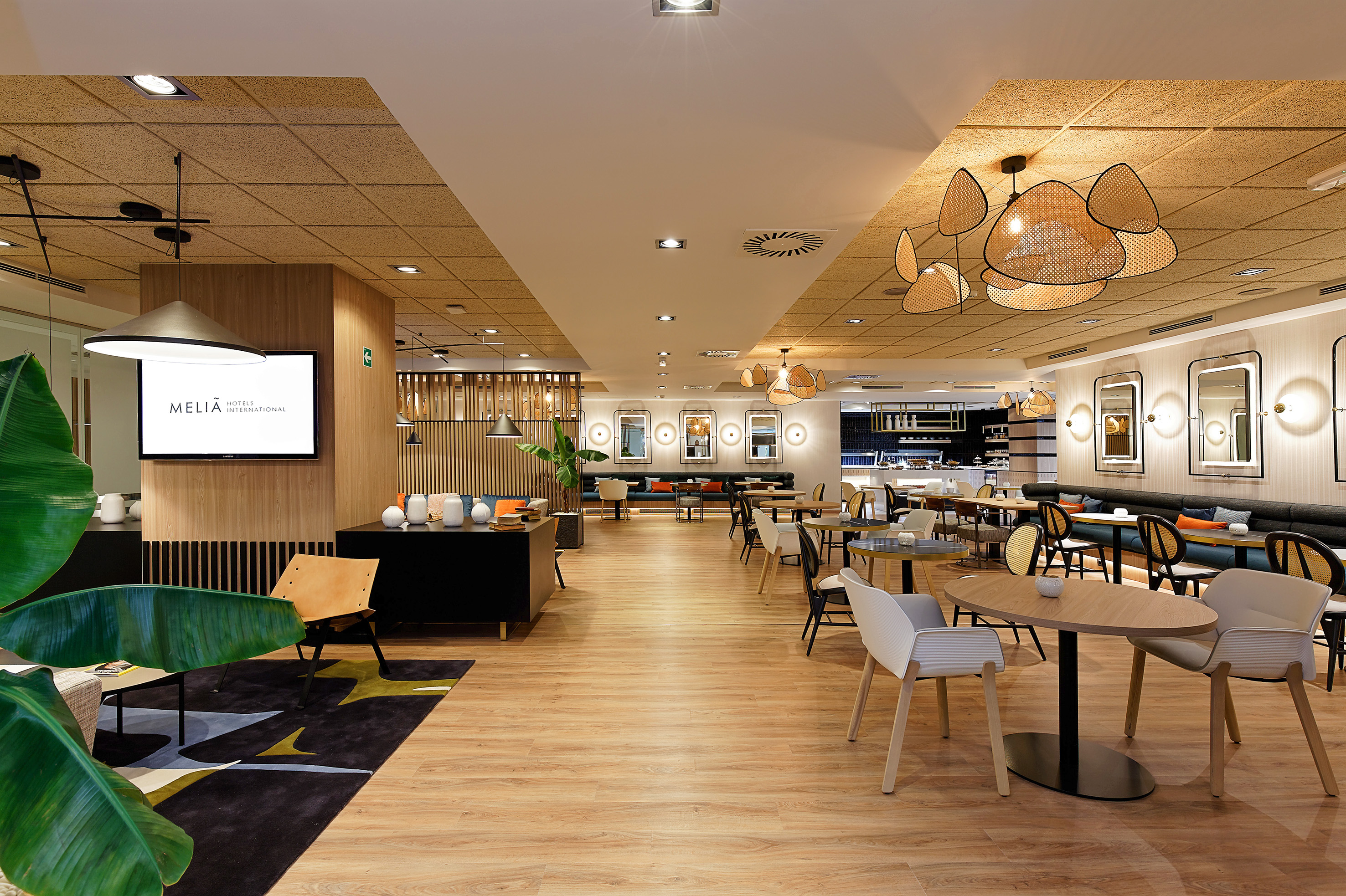 Stylish Meliá hotel restaurant with contemporary tables, chairs, and lounge seating.