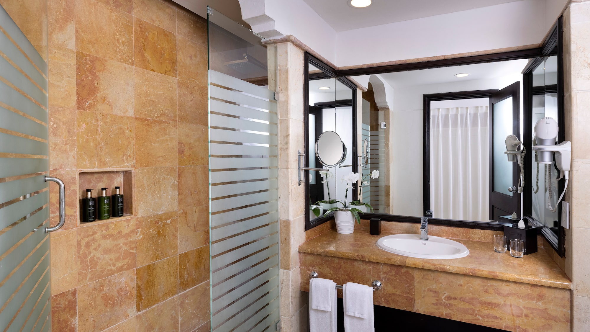 a bathroom with a shower and sink