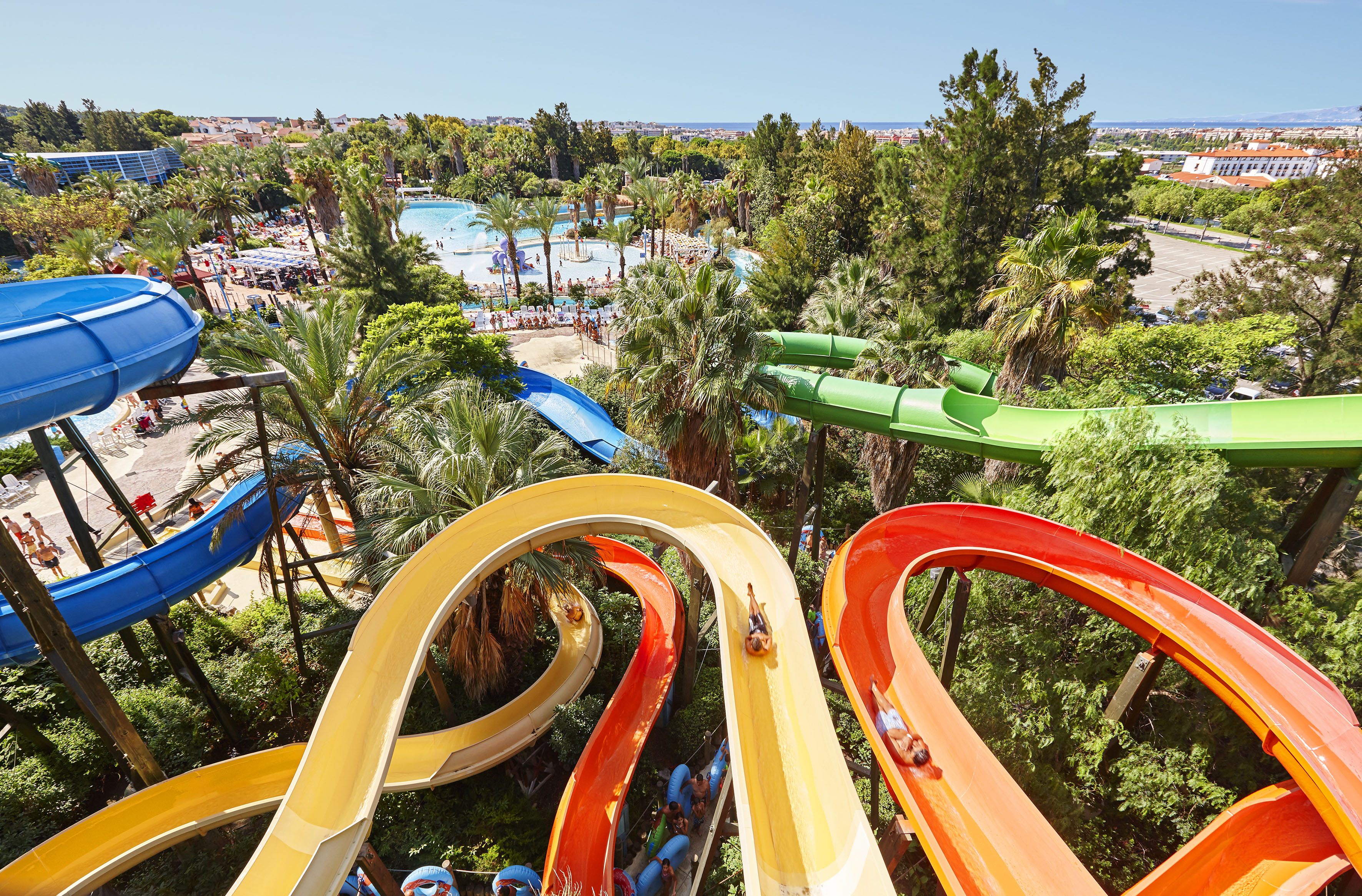a water park with colorful slides and trees