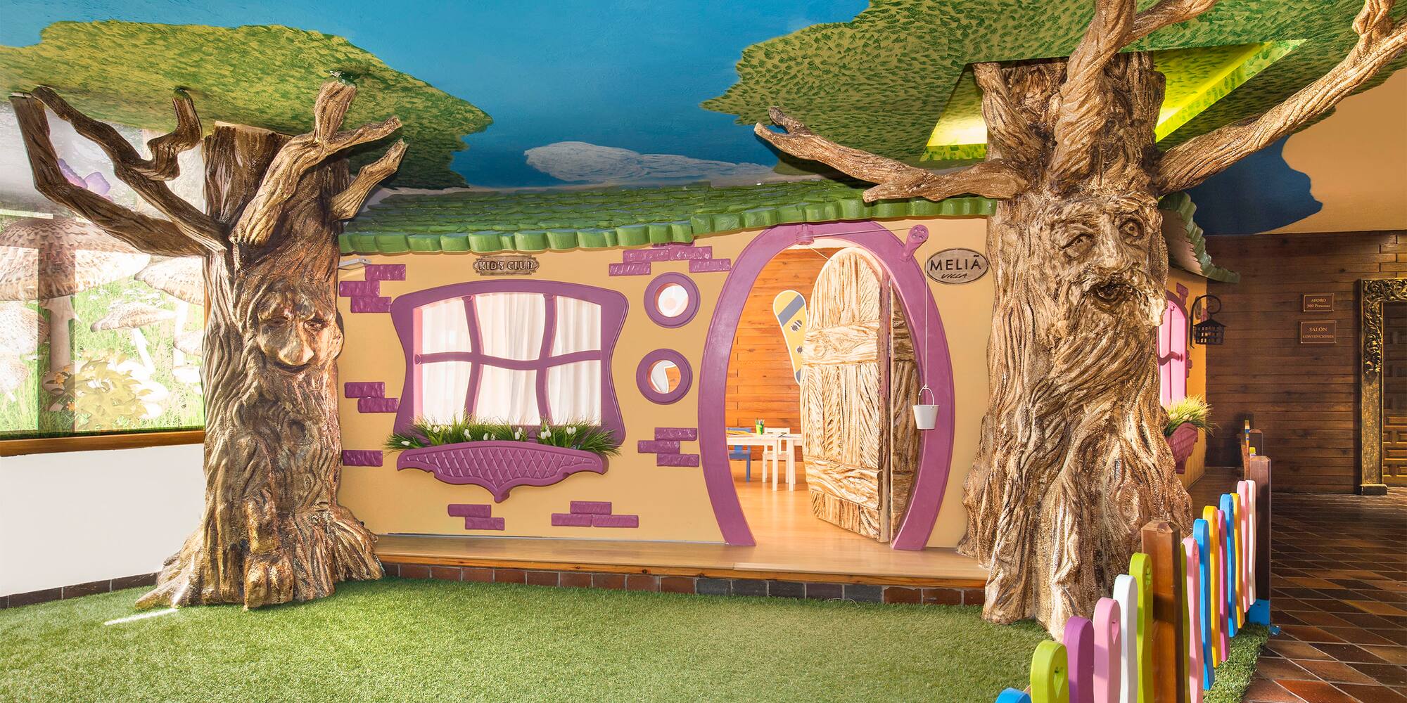 a room with trees and a fence