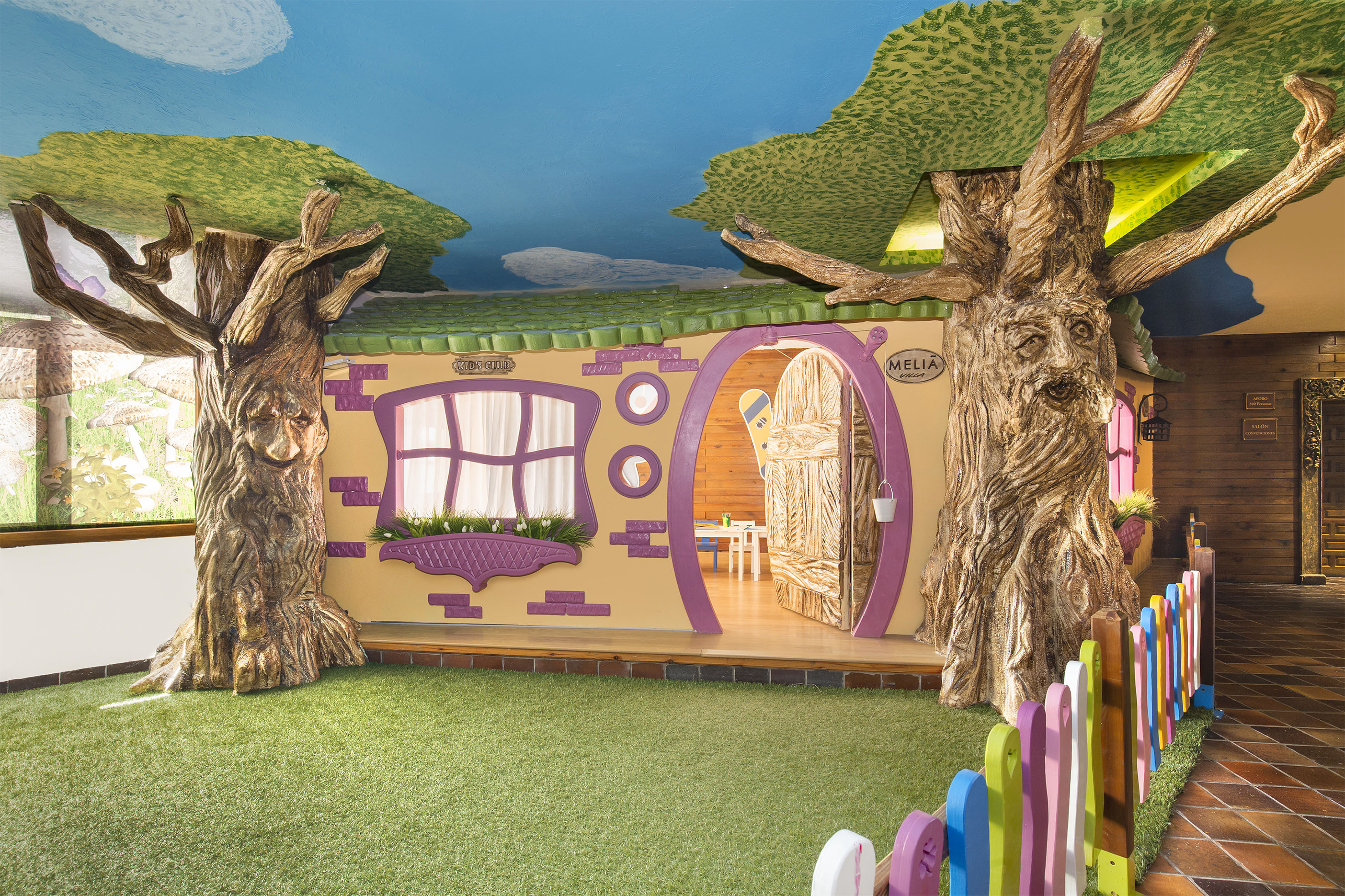 a room with trees and a fence