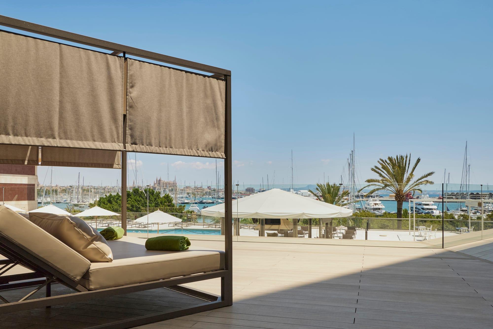 a patio with a couch and a view of the water