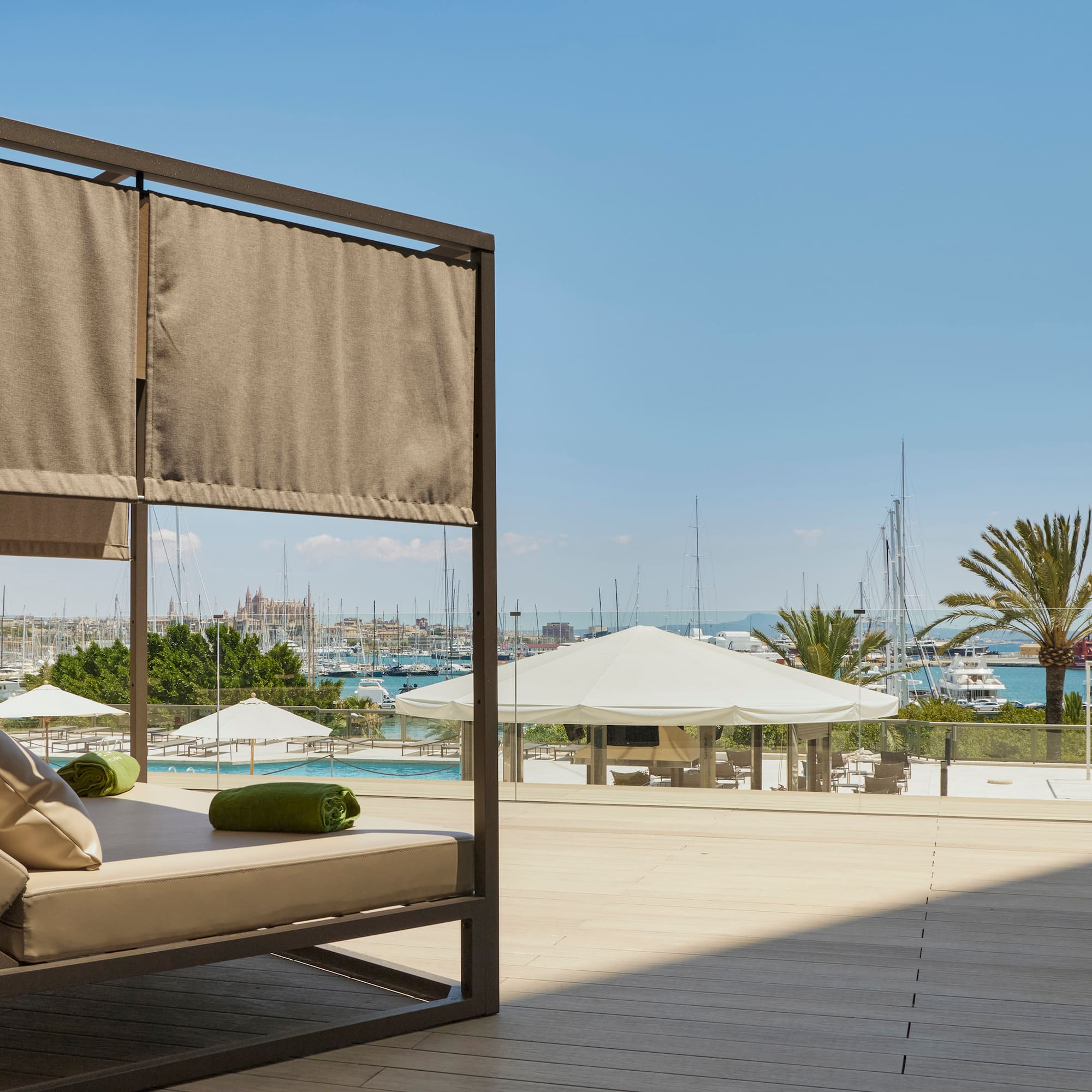a patio with a couch and a view of the water