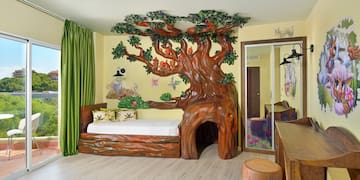 a room with a tree shaped bed