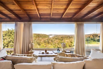a living room with a view of the mountains and trees