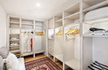 a large white closet with shelves and shelves