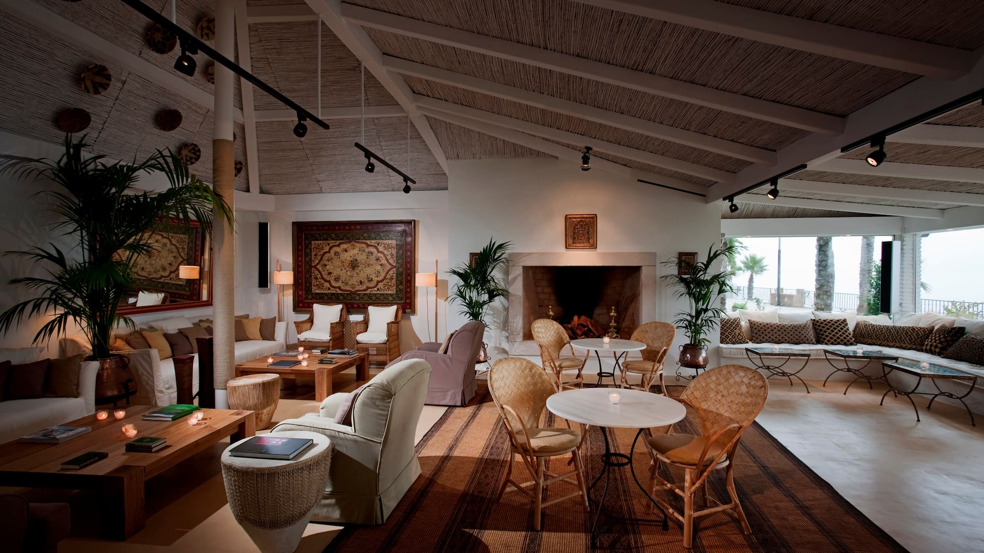 a room with a fireplace and tables