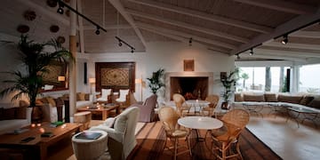 a room with a fireplace and tables