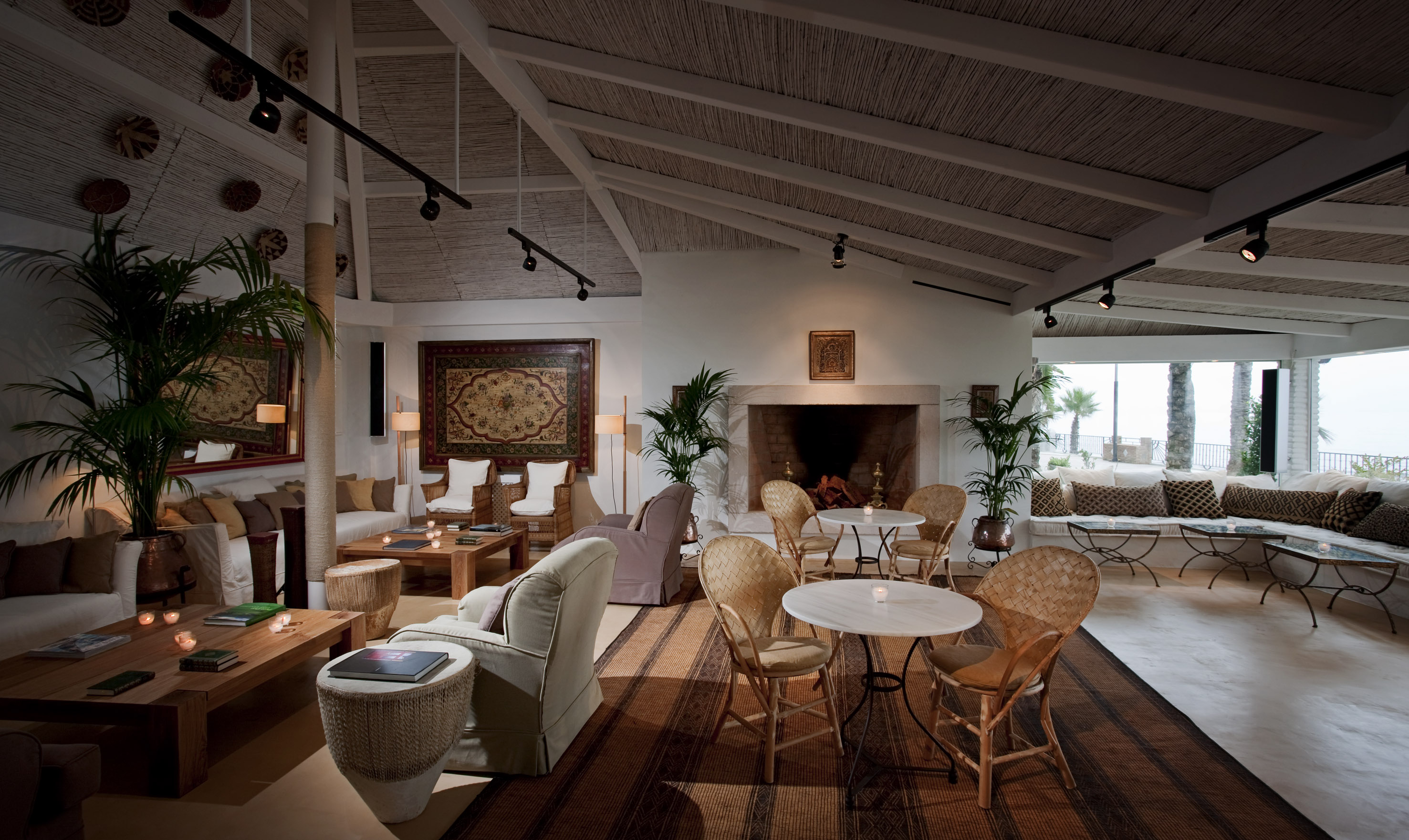 a room with a fireplace and tables