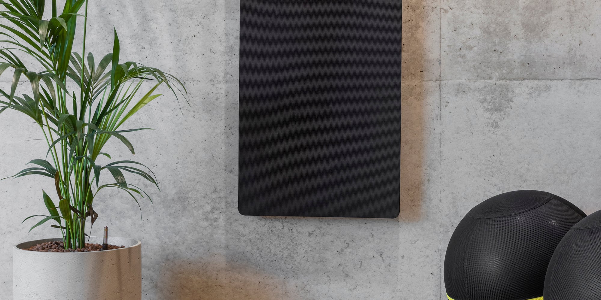 a yoga mat and yoga balls on a wooden floor