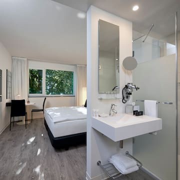 a bathroom with a bed and shower