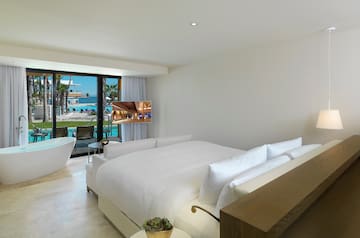 a bedroom with a bathtub and a bed