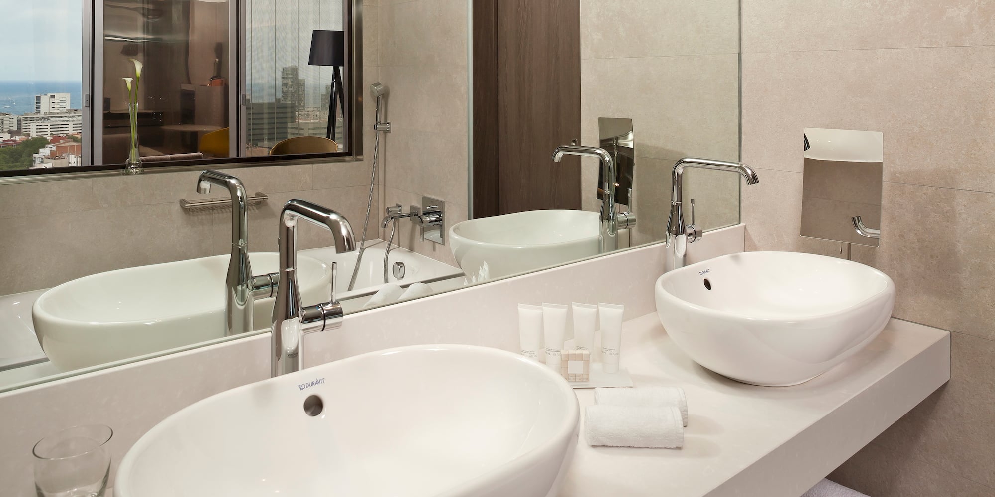 a bathroom with two sinks and a mirror