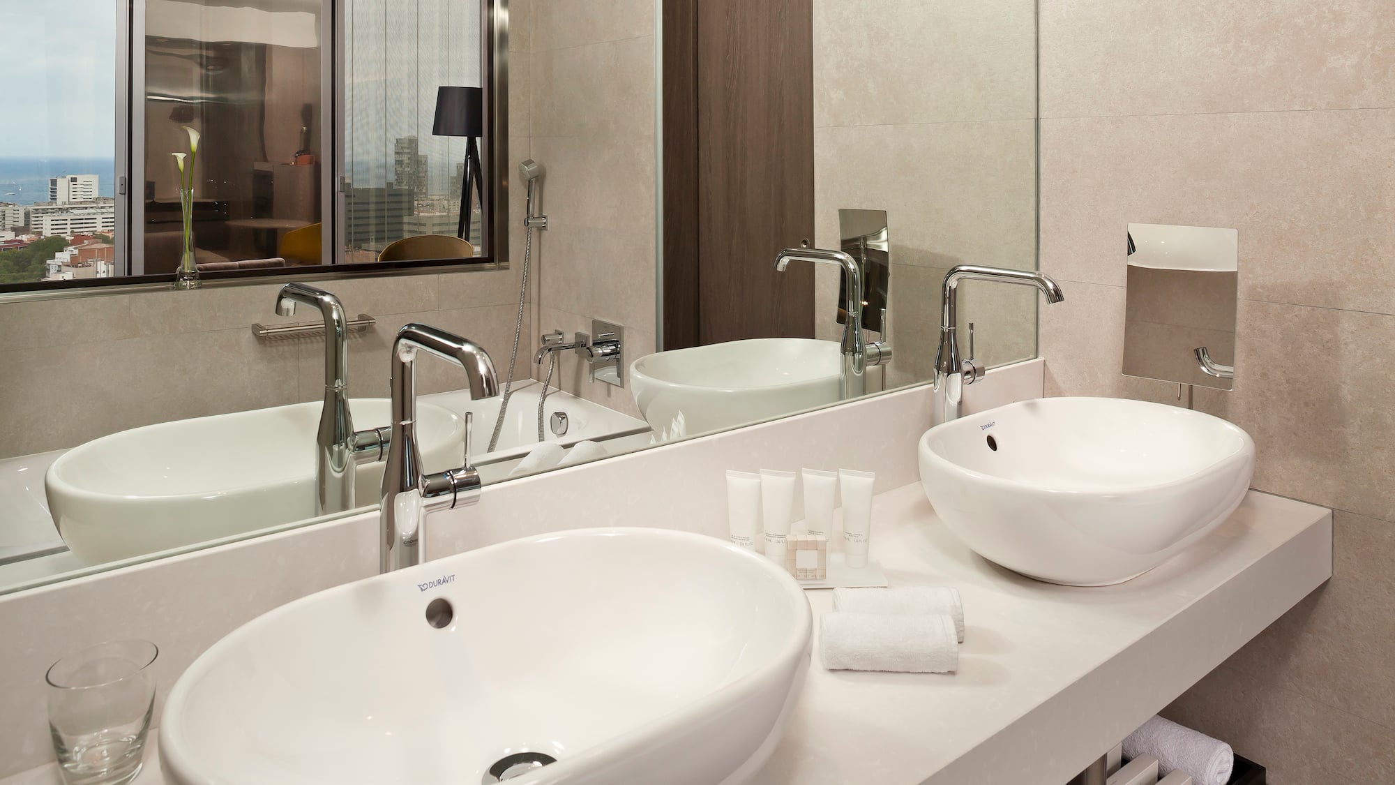 a bathroom with two sinks and a mirror