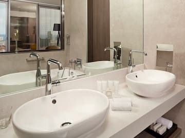 a bathroom with two sinks and a mirror