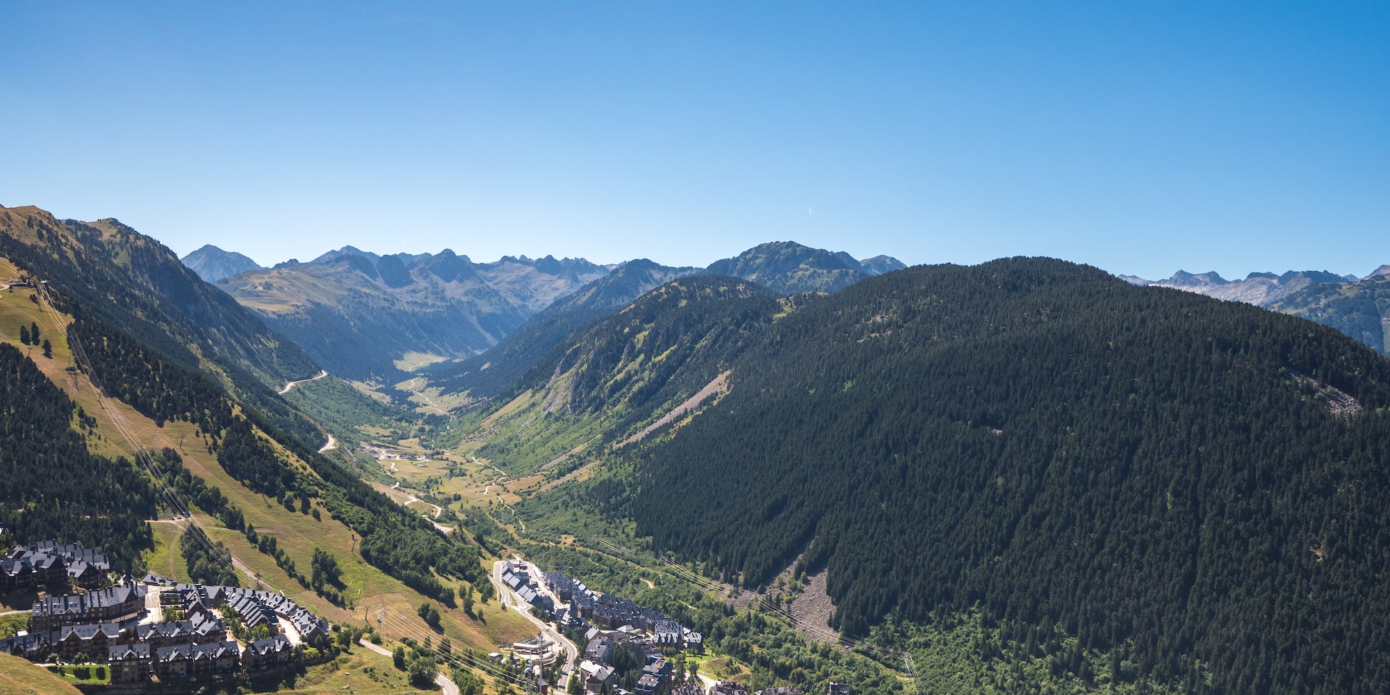 a valley with a town and mountains