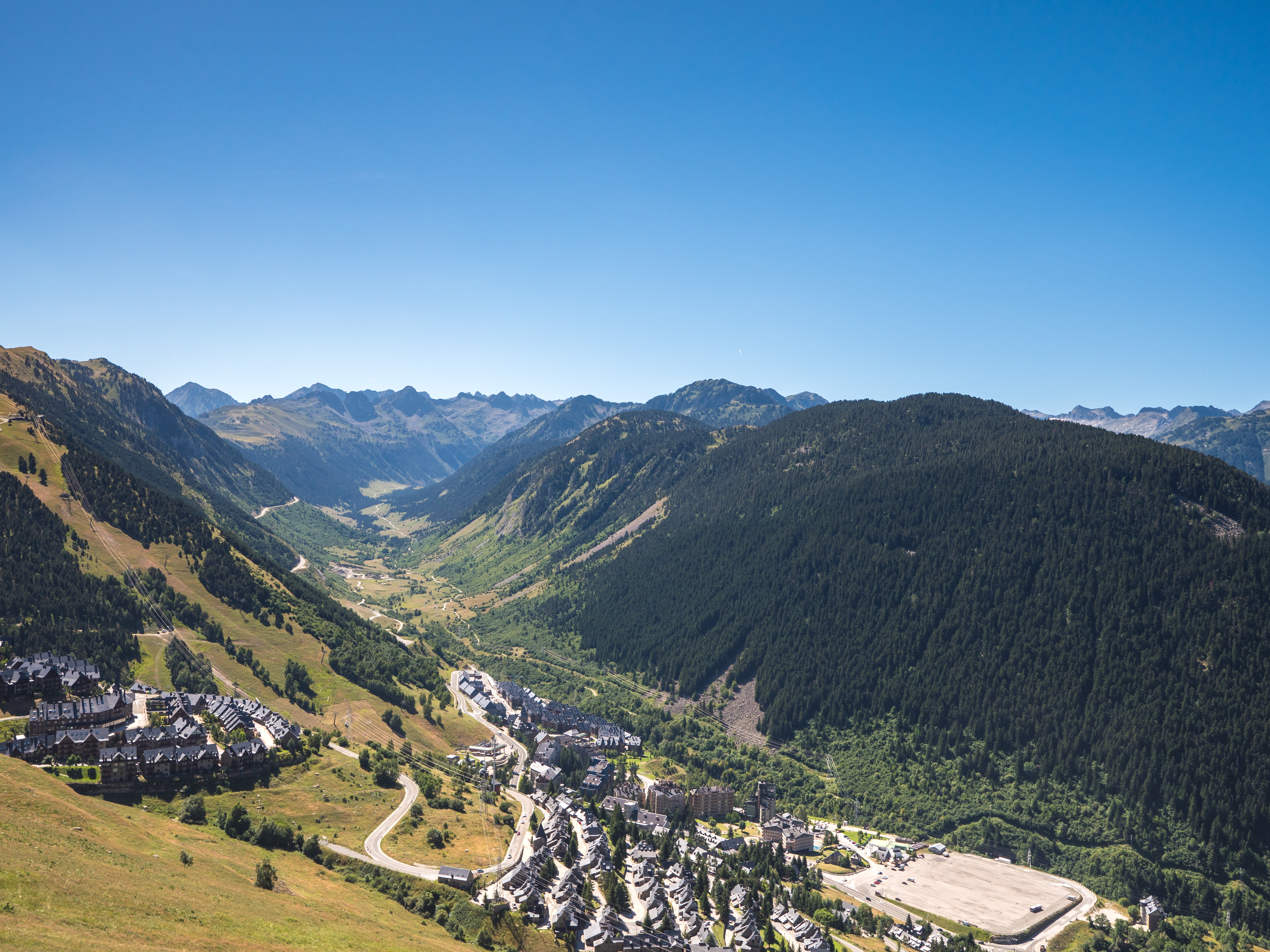 View of a ski resort town in a deep green mountain valley.