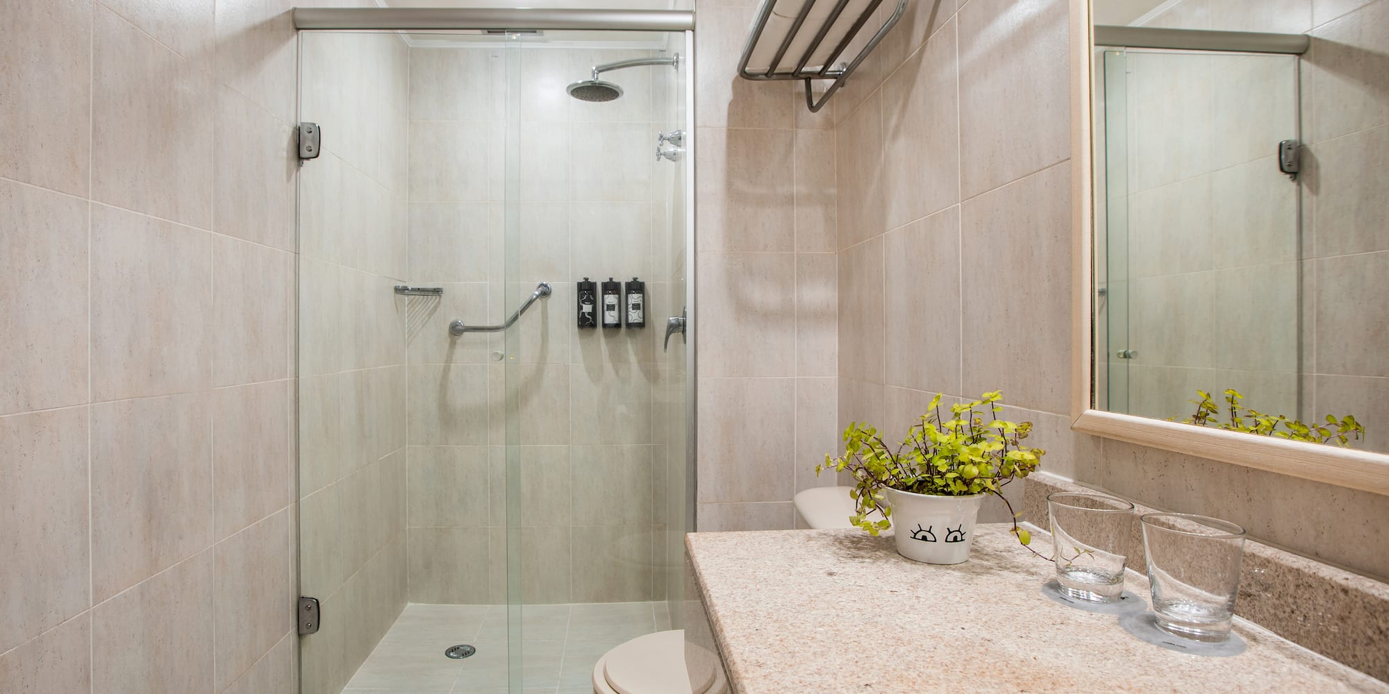 a bathroom with a glass shower and sink