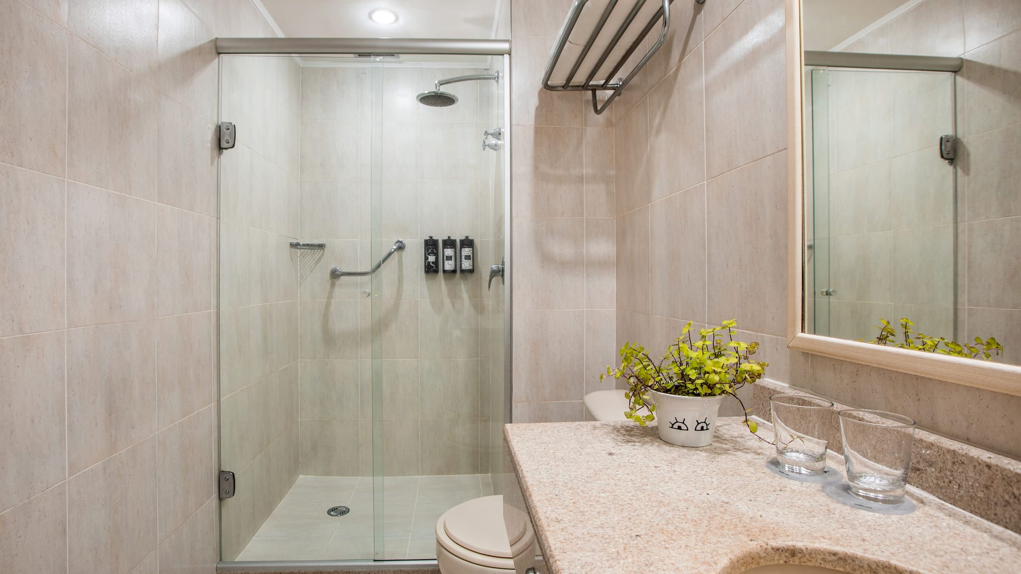 a bathroom with a glass shower and sink