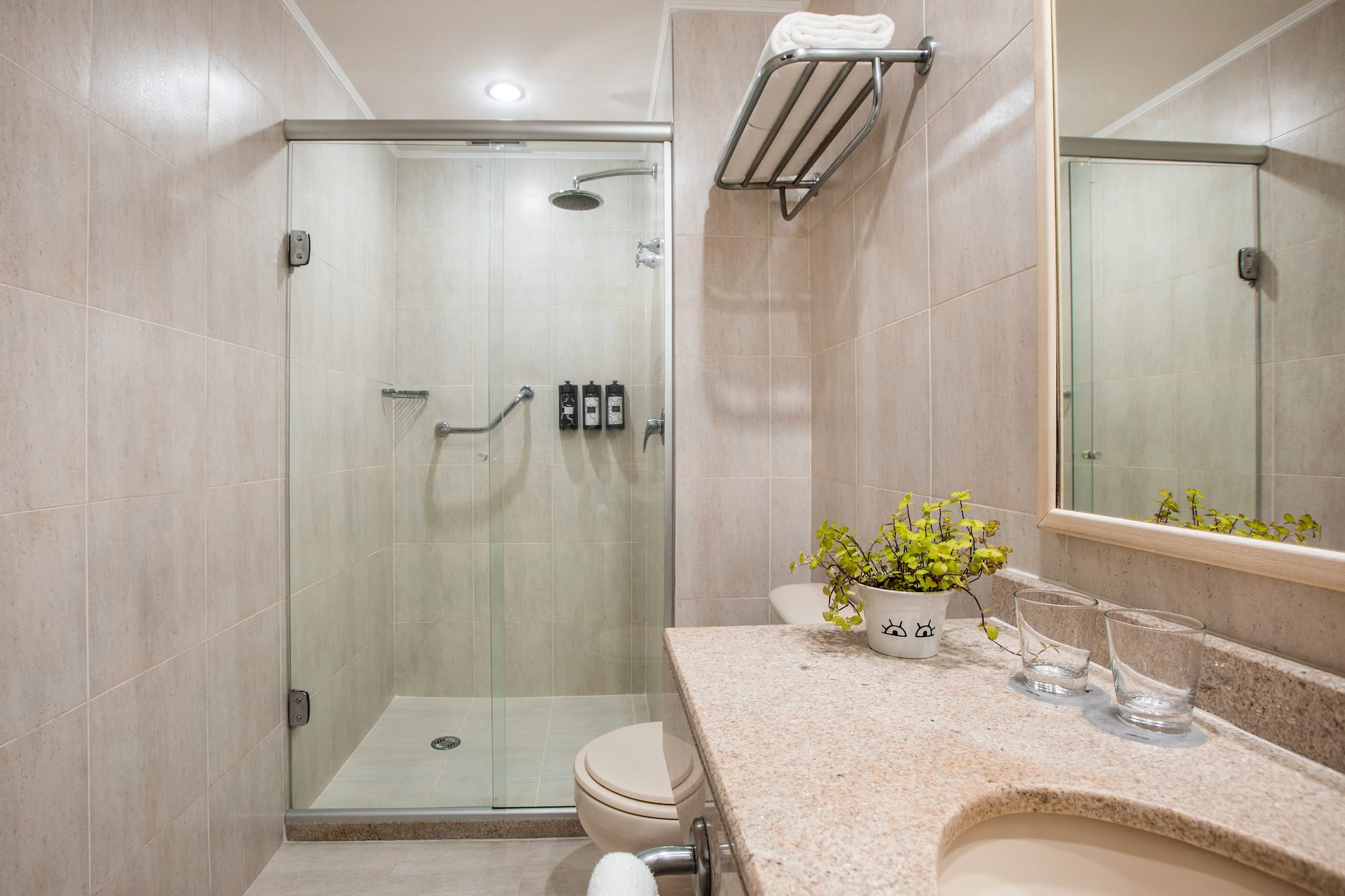 a bathroom with a glass shower and sink