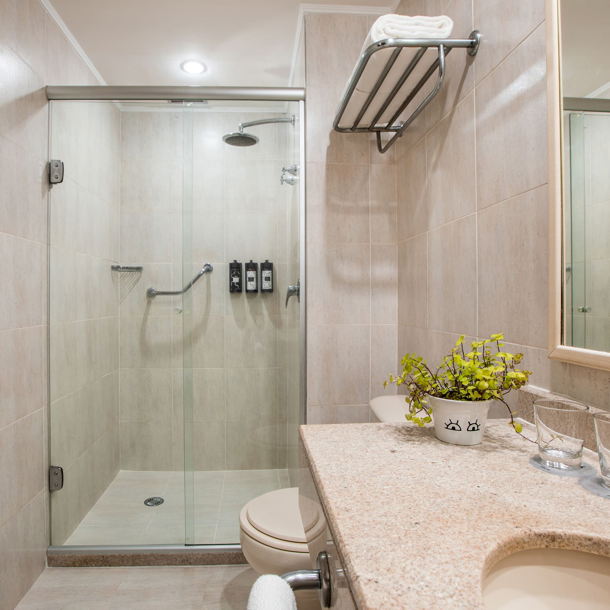 a bathroom with a glass shower and sink